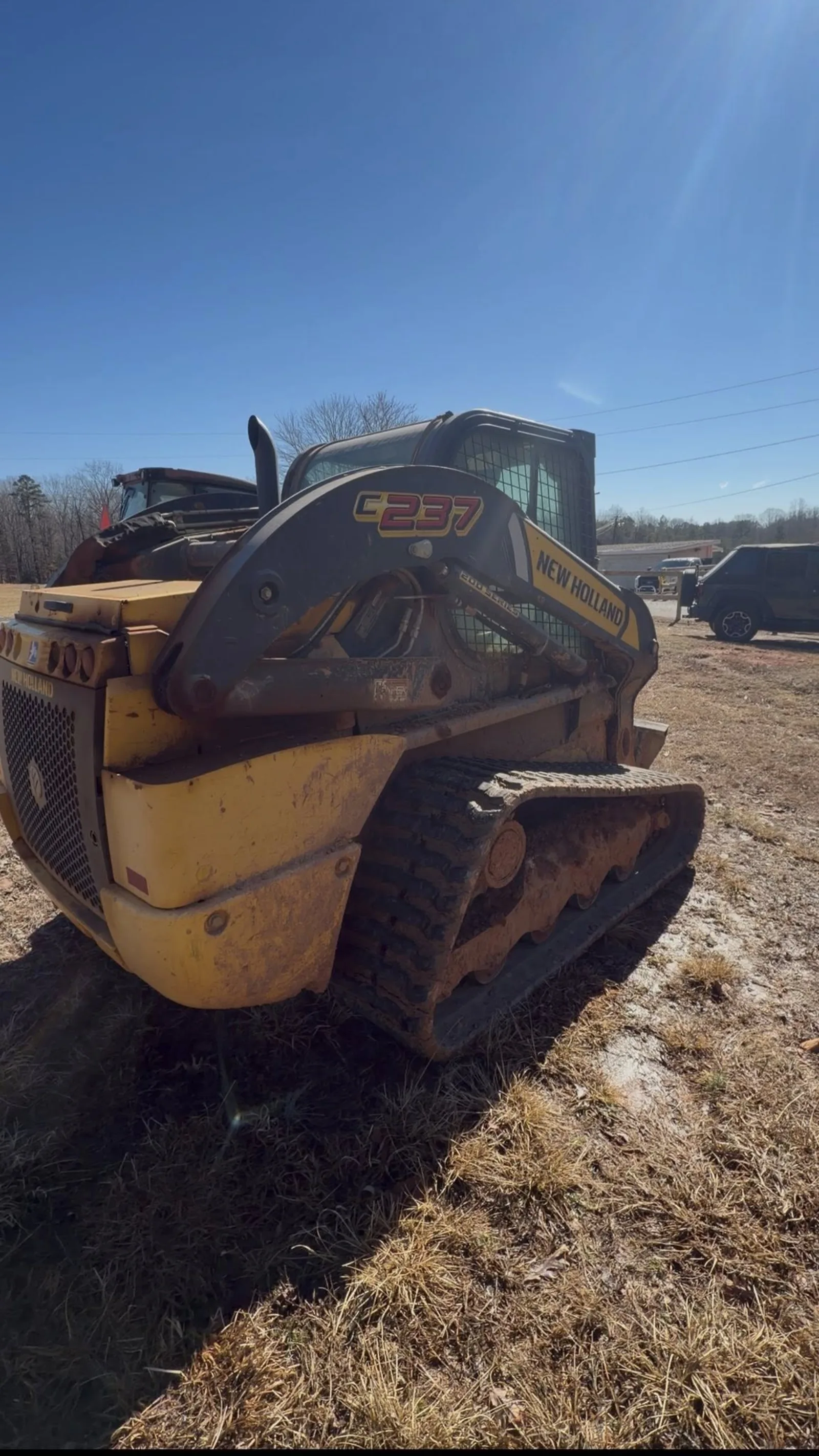 Muddy skid steer loader before heavy equipment cleaning by Romeo's Detailing